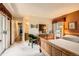 Spacious bedroom featuring a wooden dresser, green armchair and a doorway to an ensuite bathroom at 9925 W Progress Pl, Littleton, CO 80123