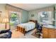 Inviting bedroom with large windows, neutral carpet and a wooden bed frame at 9925 W Progress Pl, Littleton, CO 80123