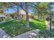 Exterior showcasing the manicured lawn and landscaping that surrounds the home at 9925 W Progress Pl, Littleton, CO 80123