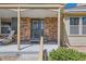 Close-up of the front entrance with a brick facade and covered porch at 9925 W Progress Pl, Littleton, CO 80123