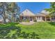 Charming home featuring a brick facade, covered porch, and well-maintained lawn at 9925 W Progress Pl, Littleton, CO 80123