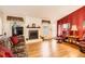Cozy living room with a fireplace, hardwood floors, and comfortable seating at 9925 W Progress Pl, Littleton, CO 80123