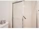A tiled shower stall with a sliding glass door and grab bar at 9925 W Progress Pl, Littleton, CO 80123
