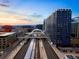 Striking aerial view of modern high rise next to Union Station with mountain views beyond at 1750 Wewatta St # 704, Denver, CO 80202