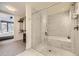 Elegant bathroom featuring a tub and shower combination and a glass door at 1750 Wewatta St # 704, Denver, CO 80202