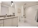 Modern bathroom with a gray vanity, bathtub and shower combination, and tiled floors at 1750 Wewatta St # 704, Denver, CO 80202