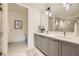 Sleek bathroom with double vanity, modern fixtures, and a separate toilet room at 1750 Wewatta St # 704, Denver, CO 80202