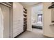 Spacious walk-in closet with custom shelving and storage solutions, leading to bedroom at 1750 Wewatta St # 704, Denver, CO 80202
