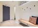 Welcoming entryway with a coat rack, bench, and light hardwood flooring at 1750 Wewatta St # 704, Denver, CO 80202