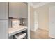 Built-in home office nook features modern gray cabinetry, sleek white countertop and neutral decor at 1750 Wewatta St # 704, Denver, CO 80202