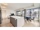Open-concept kitchen with a large island, modern appliances, and city skyline views at 1750 Wewatta St # 704, Denver, CO 80202