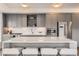 Modern kitchen with stainless steel appliances, a large island, and stylish gray cabinetry at 1750 Wewatta St # 704, Denver, CO 80202