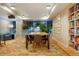 Well-lit library with bookshelves, a table, and a leafy green plant at 1750 Wewatta St # 704, Denver, CO 80202