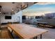 Large rooftop patio with dining areas, lounge seating, and city views at 1750 Wewatta St # 704, Denver, CO 80202