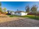 Spacious backyard featuring gravel area, lawn, fenced perimeter, and detached shed for storage at 1014 Ponderosa Cir, Longmont, CO 80504