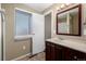 Bathroom with tiled floor, dark wood cabinets, and a large mirror at 1014 Ponderosa Cir, Longmont, CO 80504