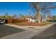 Corner lot featuring a single-story home with a well-maintained lawn and a detached two-car garage at 1014 Ponderosa Cir, Longmont, CO 80504