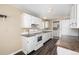 Bright kitchen featuring white cabinetry, countertops, and modern appliances at 1014 Ponderosa Cir, Longmont, CO 80504