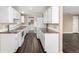 Functional kitchen featuring white cabinetry, countertops, and modern appliances at 1014 Ponderosa Cir, Longmont, CO 80504