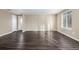 Bright living room featuring hardwood floors, neutral walls, and a large window at 1014 Ponderosa Cir, Longmont, CO 80504
