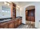 Elegant bathroom with double vanity, granite counters, and a large mirror at 55 N Pines Trl, Parker, CO 80138