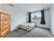 Cozy bedroom featuring a wooden dresser and a window with curtains at 55 N Pines Trl, Parker, CO 80138