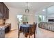 Bright dining area with hardwood floors and sliding glass doors leading to a deck at 55 N Pines Trl, Parker, CO 80138