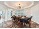 Bright dining room featuring a large table, six chairs, and bay windows at 55 N Pines Trl, Parker, CO 80138