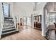 Two-story foyer with hardwood floors, a staircase, and a view of the living room at 55 N Pines Trl, Parker, CO 80138