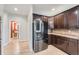 Modern kitchen features dark wood cabinets, granite counters, and stainless steel appliances at 55 N Pines Trl, Parker, CO 80138