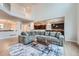 Bright living room with hardwood floors, L-shaped sofa, and an open concept view to the kitchen at 55 N Pines Trl, Parker, CO 80138