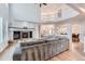 Open living room showcasing hardwood floors, a fireplace, and a view of the dining area at 55 N Pines Trl, Parker, CO 80138