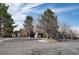 View of the neighborhood street featuring buildings surrounded by green trees and landscaping at 9212 E Arbor Cir # F, Englewood, CO 80111