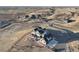 Aerial view of a home showcasing its prime location, set against a backdrop of rolling hills at 10151 E 138Th Pl, Brighton, CO 80602