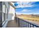 A balcony has black metal railings with panoramic views of the surrounding landscape and other neighborhood homes at 10151 E 138Th Pl, Brighton, CO 80602