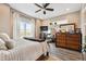 Bedroom featuring a large window with natural light, wood-look floors, and a ceiling fan at 10151 E 138Th Pl, Brighton, CO 80602