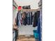 A well-organized closet has hanging racks for clothes and plenty of storage space for laundry and cleaning supplies at 10151 E 138Th Pl, Brighton, CO 80602