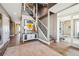 Grand entryway with staircase, hardwood floors, a charming rug and elegant console table at 10151 E 138Th Pl, Brighton, CO 80602