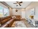 Inviting living room showcasing a leather sectional, a window, and unique decor elements at 10151 E 138Th Pl, Brighton, CO 80602