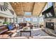 Open-concept living room with vaulted ceilings, beautiful decor, and a cozy fireplace at 10151 E 138Th Pl, Brighton, CO 80602