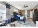 This stylish main bedroom features wood floors, a ceiling fan, a king bed, and an ensuite bathroom at 10151 E 138Th Pl, Brighton, CO 80602