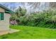 Lush backyard with green lawn and mature trees, offering a serene outdoor space at 3000 Alkire St, Golden, CO 80401