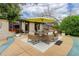 Backyard patio featuring a dining set with umbrella, offering a perfect outdoor dining area at 3000 Alkire St, Golden, CO 80401