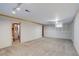 Unfinished basement space with neutral carpet and storage cabinets offers room for customization at 3000 Alkire St, Golden, CO 80401