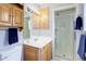 Bathroom featuring coordinated cabinetry, a framed glass shower, and modern fixtures at 3000 Alkire St, Golden, CO 80401