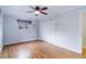 Bedroom featuring hardwood flooring, a window, and a closet for ample storage space at 3000 Alkire St, Golden, CO 80401