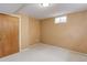 Tan-painted bedroom with neutral carpet and a small window allowing natural light at 3000 Alkire St, Golden, CO 80401