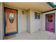 Welcoming front porch with decorative door, stylish light fixture, and colorful secondary door at 3000 Alkire St, Golden, CO 80401