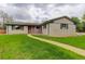 Inviting single-story home featuring a walkway leading to the front entrance and lush green lawn at 3000 Alkire St, Golden, CO 80401