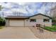 Spacious garage, concrete driveway, and charming fenced front yard of home at 3000 Alkire St, Golden, CO 80401